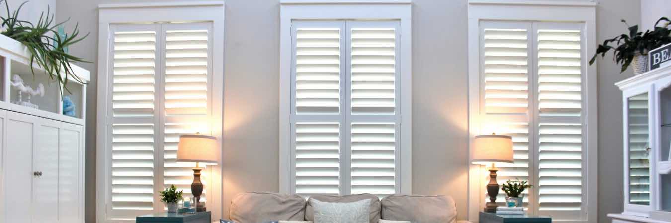 Closed Polywood shutters on three living room windows